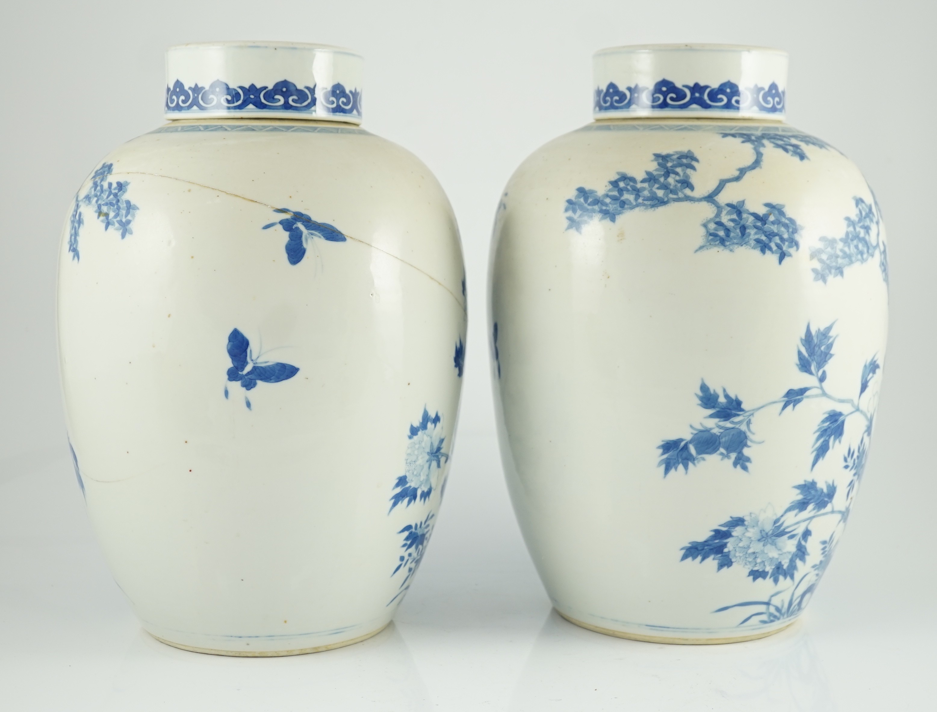 A pair of large Chinese blue and white ovoid jars and associated covers, 19th century, 34.5cm high, damage and repairs